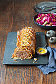 Minced meat in puff pastry and pickled red cabbage with walnuts and apples