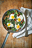 Fried eggs with mushrooms and kale