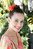 A young woman wearing flowers in her hair