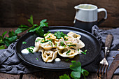 Vegan ravioli with spinach filling on parsnip and cashew sauce