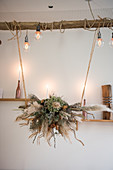 Arrangement of dried flowers suspended over table