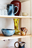 Retro stoneware crockery in refurbished cupboard