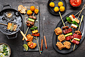 Fondue with oil: beef skewers, salmon bites, pepper and cheese skewers