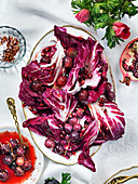 Red treviso salad with grapes, chilliflakes and pomergranate for Valentines day