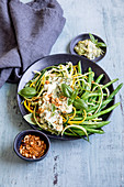 Zoodles with beans, avocado dressing and dukkah (keto cuisine)