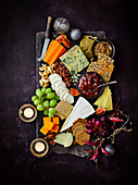 Cheeseboard with nuts, crackers and grapes