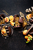 Festive chocolate cake served with oranges and pistachio brittle