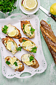 Bruschetta with cod, lemon and parsley