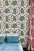 Vintage wallpaper with pattern of exotic objects in bedroom