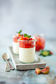 Panna cotta in a glass with compote made from strawberries and rhubarb