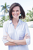 A young woman wearing a light, striped shirt