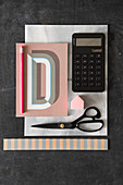 Notebook, calculator and scissors