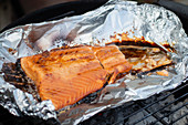 Marinated salmon on the BBQ in foil