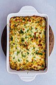 Baked vegetarian cheesy cabbage casserole topped with a golden top in a baking pan