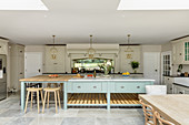 Cream country-house kitchen with huge pale blue island counter