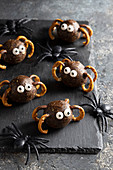Halloween spider truffles from dates, peanut butter and granola, leggs from precels, sugar eyes