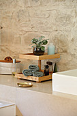 DIY wooden stand against stone wall in bathroom
