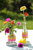 Glass bottles wrapped with woolen yarn used as vases