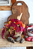 Colourful potatoes and late-summer bouquet with wooden cutlery