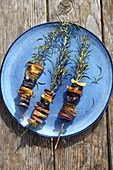 Colourful potatoes grilled on sprigs of rosemary