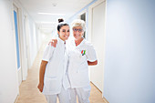 Nurses laughing in corridor
