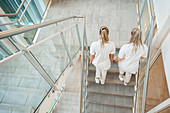 Nurses walking down the stairwell of a hospital