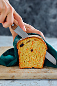 Cutting carrot loaf with cranberries