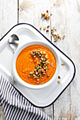 Pumpkin soup with pistachio and nutty topping