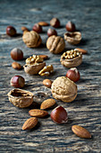 Walnuts, hazelnuts and almonds on a wooden surface