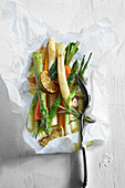 Vegetables in parchment paper with rosemary and limes