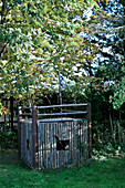 Girl looking out of play house in garden