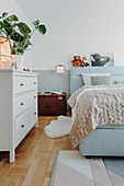 Cosy bedroom in pale blue and white