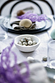Speckled chocolate eggs on Easter table set in a natural style
