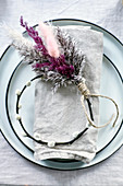 Circlet of willow and dyed grasses on plate