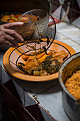 Tunisian couscous with vegetables on a clay plate