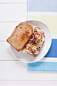 A cream cheese, cucumber and bean sprout sandwich