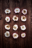 Dried apple slices on a wooden surface