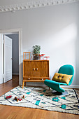 Sideboard and turquoise designer chair on Berber rug