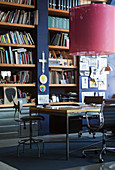 Desk and chairs in library with dark blue wall