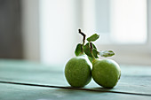 Two butter pears on a wooden table