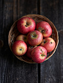 Fresh red apples in a wicker basket