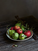 Apples and pears on a rustic wooden table