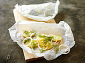Herring with onions and apples in parchment paper