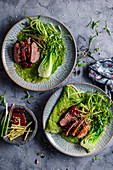 Green pancakes with glazed duck and paksoi (Asia)