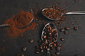 Types of coffee grounds instant, powder and coffee beans in spoons