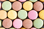 Colorful macaroons displayed in wooden surface