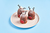 Deer head shaped desserts placed on plate against blue background