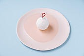 Bauble shaped coconut dessert on plate