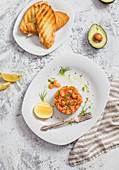 Salmon tartare served with toasted bread and avocado