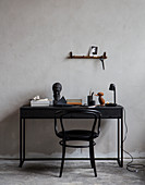 Black bistro chair at desk with vintage accessories